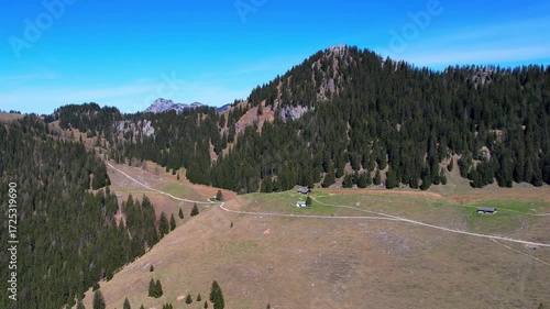 Cinematic 4K Aerial Drone video of flying over Brünnstein mountain in German Alps on a beautiful sunny summer day perfect for hiking with surrounding mountain peaks covered in ice and snow