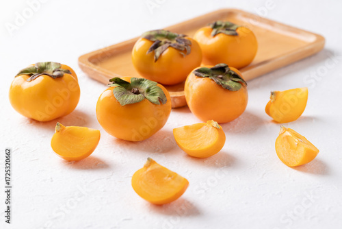 Sliced fresh ripe persimmon on white background, Autumn sweet fruit