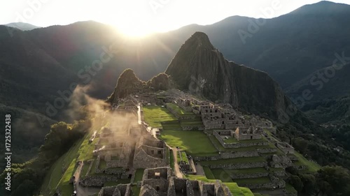 Machu picchu at sunrise, with the sun shining over the mountains and the ancient city, creating a beautiful and aweinspiring scene of the historic landmark