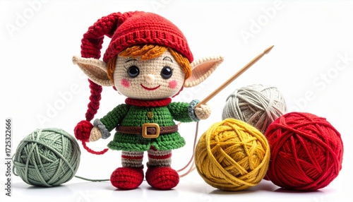 Cute Knitted Elf Doll with Pointy Hat and Green Outfit Surrounded by Colorful Yarn Balls on White Backdrop