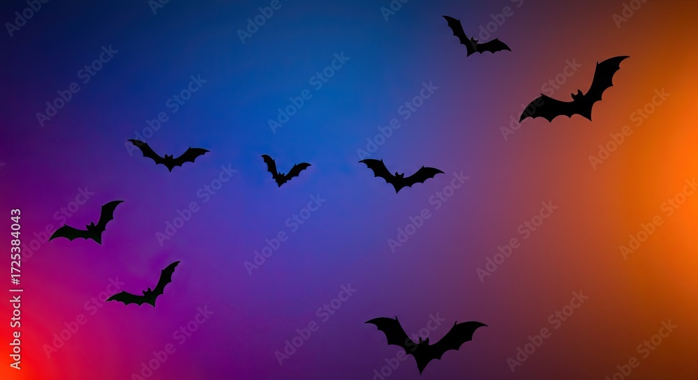 Fototapeta premium Spooky bats silhouette flying across a vibrant Halloween night sky