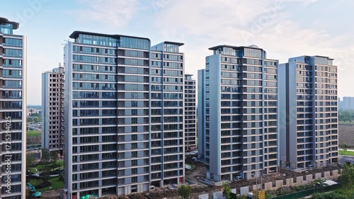 Aerial shot of modern high rise residential apartment buildings under construction in a new real estate development zone