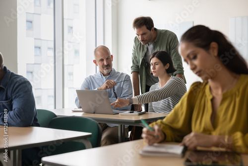 Tutor engaging with students in adult education