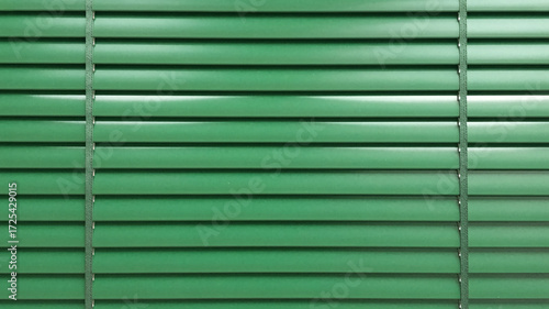 Stylish green blinds provide privacy and shade creating a calming atmosphere for any room, offering a touch of modern design and simplicity