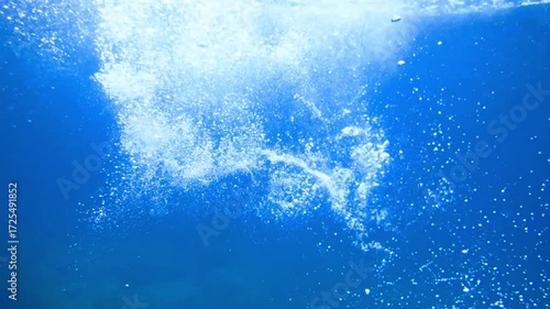 Light filtering down through blue water. Underwater sunlight in deep sea. Light viewed from blue abyss. Underwater sunlight shining deep with ripples on wave surface ocean ray, Under water Slow motion