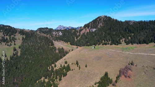 Cinematic 4K Aerial Drone video of flying over Brünnstein mountain in German Alps on a beautiful sunny summer day perfect for hiking with surrounding mountain peaks covered in ice and snow