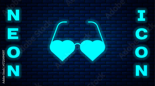 Glowing neon Heart shaped love glasses icon isolated on brick wall background. Suitable for Valentine day card design. Vector