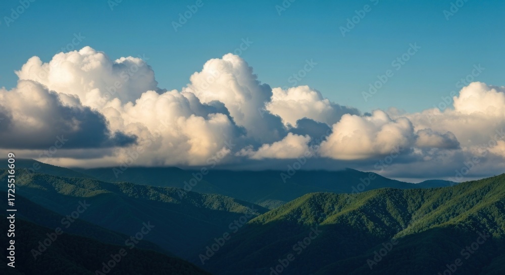 Obraz premium Panoramic mountain vista with cumulus clouds
