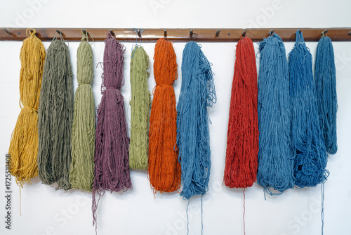 Silks thread hangs from a loom at the Turkish silk carpets workshop in  Avanos