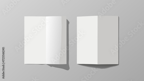 Two blank white folded brochures or flyers on a gray background