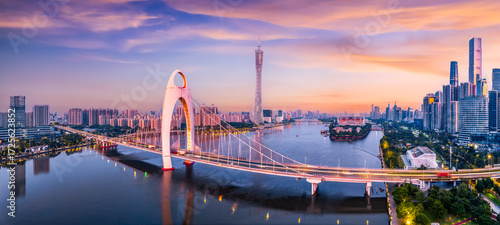 Cuadro en lienzo Modern bridge and city financial district skyline under a colorful sunset sky in Guangzhou