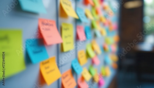 Colorful sticky notes on a whiteboard in a blurred office setting.