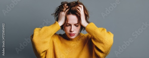 The Woman in a Yellow Sweater Gripping Her Head in Frustration and Thoughtfulness