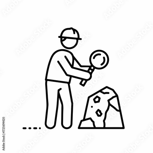 Archaeologist meticulously examining a rock specimen with a magnifying glass at an excavation site.