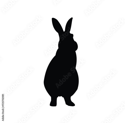 A black silhouette of a rabbit lying down against a white background.
