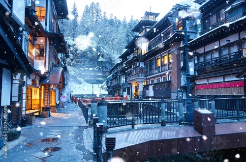 Wallpaper Mural Dawn scenery of Ginzan Onsen after snowfalls, a famous Japanese hot spring town in Obanazawa, Yamagata, Japan, with bridges over a stream flanked by antique wooden buildings on a cold winter morning  Torontodigital.ca