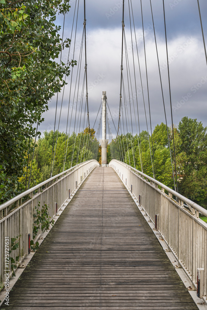Obraz premium Scenic vertical view of Michel Serres footbridge across Garonne river, Agen, Lot-et-Garonne, France