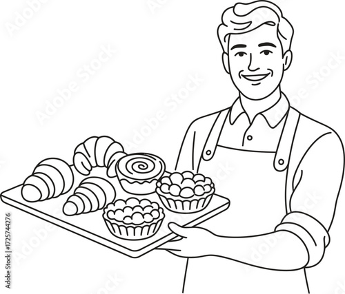 Smiling baker holding a tray of fresh pastries and croissants