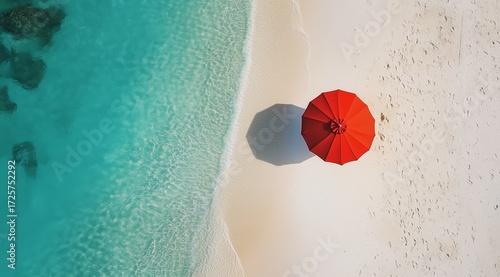 Relaxing Beach Scene With a Red Umbrella on White Sand and Clear Blue Water