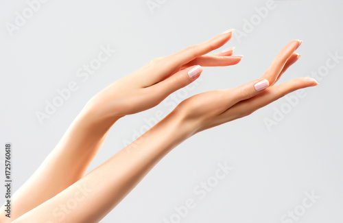 Hand skin care. Closeup of beautiful woman hands with light manicure on nails . Cream for hands and treatment.
