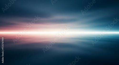 A blurred seascape shows a pink and white horizon line between dark sky and water