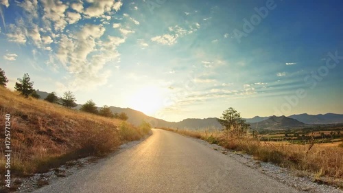 Golden hour, beautiful countryside, fields, dramatic sky, POV car drive
