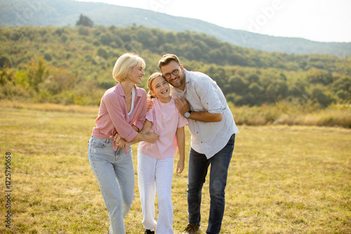 Joyful family enjoys a sunn...