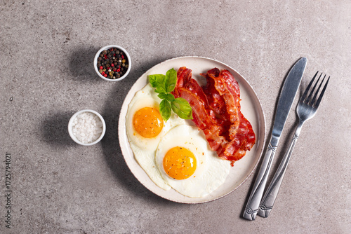 Delicious traditional English breakfast with fried eggs and bacon