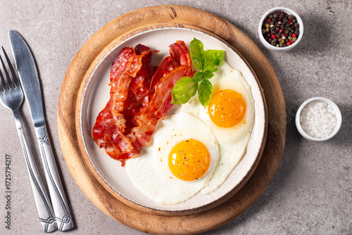Delicious traditional English breakfast with fried eggs and bacon