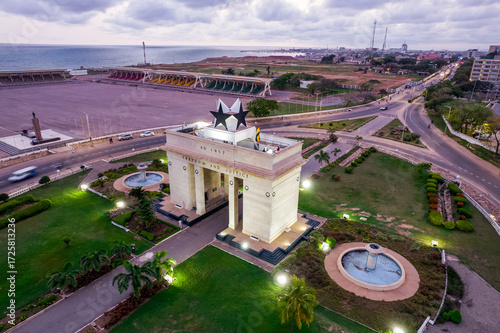 Aerial view of Accra Ghana Black Star Gate illuminated at dusk, landmark monument.