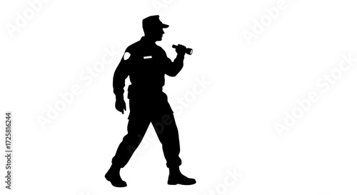 Silhouette of a security guard on patrol with a flashlight