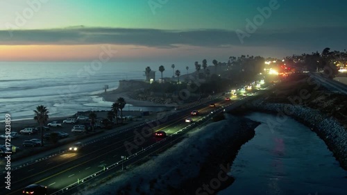 Wallpaper Mural Coastal highway illuminated at dusk with cars driving along the ocean Torontodigital.ca