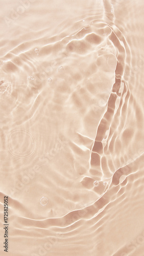 A small, silver-scaled fish glides gracefully through the tranquil, sun-dappled water of a serene pond. Its gentle movement creates delicate, concentric ripples that expand across the surface. The bac