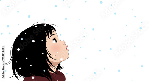 Young girl looking up at falling snowflakes in winter scene  