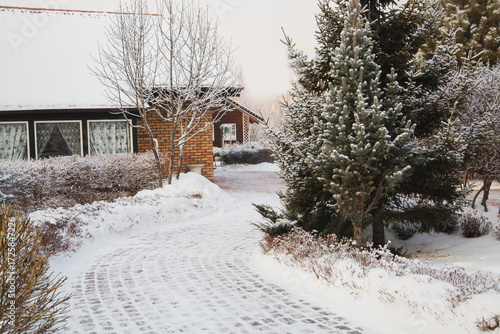 Fragment of a landscape park in winter. Alleys, garden house, bushes, trees. A place to relax and unwind in a big city.