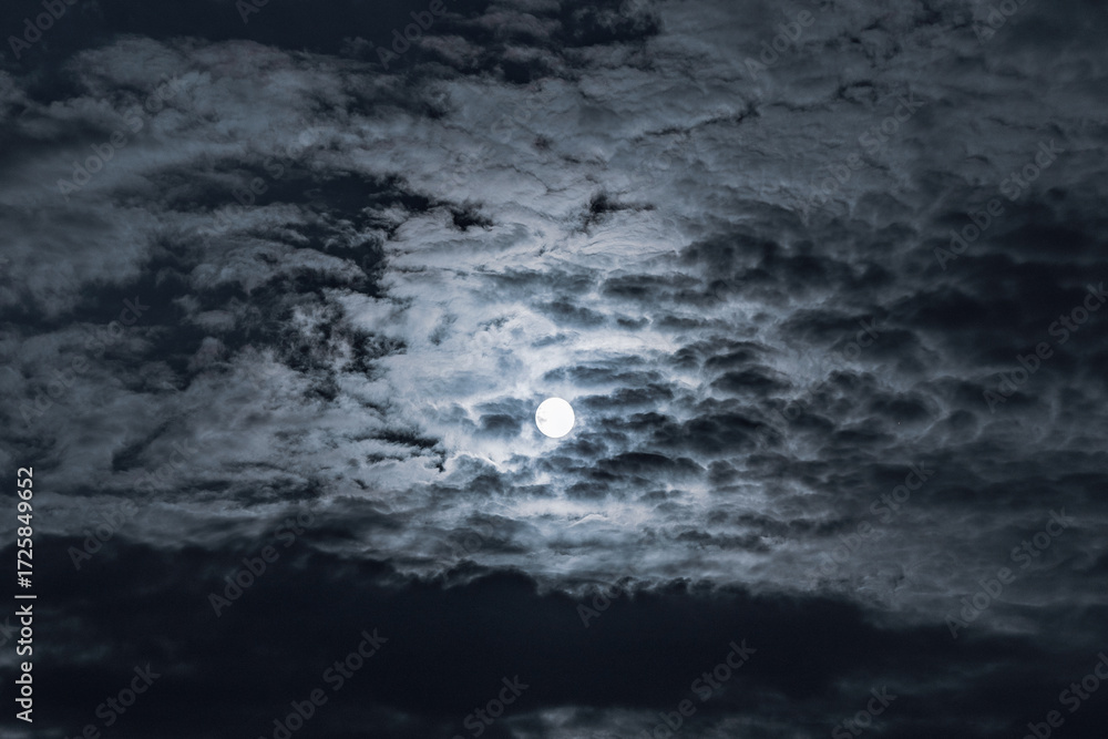 Fototapeta premium Dramatic clouds in the moonlight. Full moon in the night sky