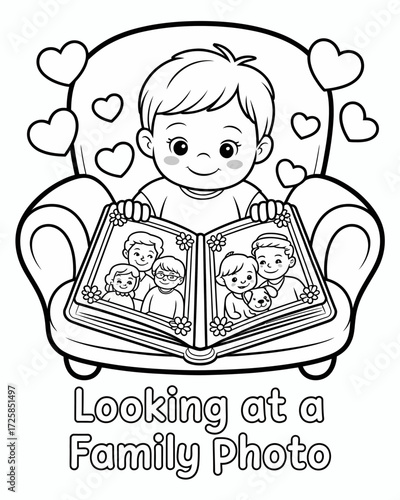 A young boy reads a book with family photos inside happily smiling