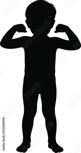 Silhouette of a young boy flexing his muscles a powerful pose