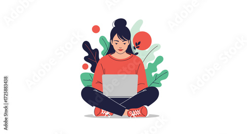 Young woman sitting cross legged on the floor using her laptop.