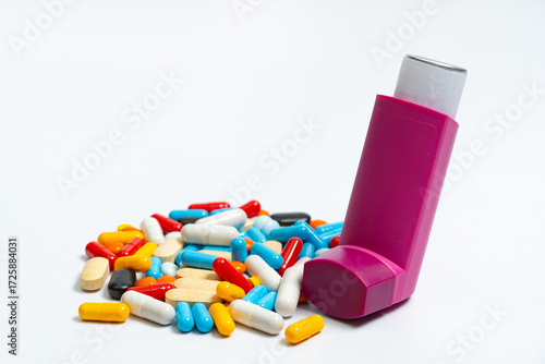 Multicolored tablets and capsules and aerosol spray for asthmatics, allergies, on white background. Bronchodilator medicine with salbutamol for patients with asthma, allergy, chronic pulmonary disease
