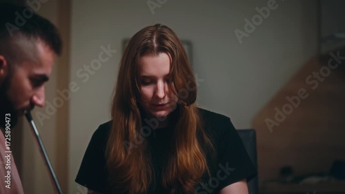 A cozy evening in a modern kitchen where a small group of friends gathers around a round table to play a board game