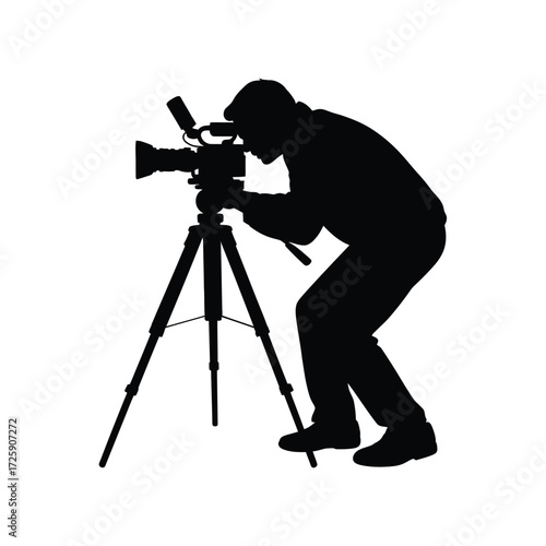 Silhouette of a videographer operating a camera on a tripod