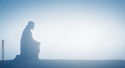 Serene silhouette of kneeling figure bathed in light blue gradient background