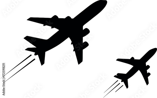 Silhouette of two airplanes soaring into the sky with trails