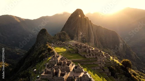 Majestic aerial view of machu picchu, the ancient inca citadel nestled high in the andes mountains, illuminated by the golden rays of the rising sun, peru
