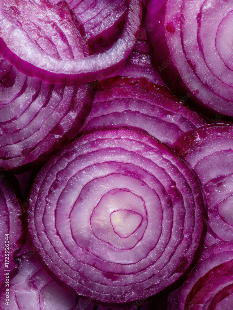 Fototapeta premium Close-up view of fresh sliced red onions showcasing their vibrant color and layers in a uniform pattern found in a kitchen setting