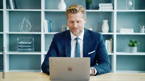 Professional businessman working on laptop in modern office, connecting with clients, presenting ideas and closing deals during a productive workday