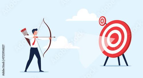 A businessman aims his bow and arrow at a bullseye target.