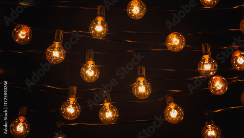 Background - electric garland with incandescent bulbs, yellow warm light