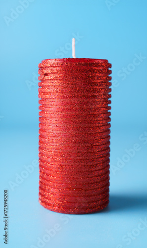 New year and christmas decoration with blurred candle over blue background.
